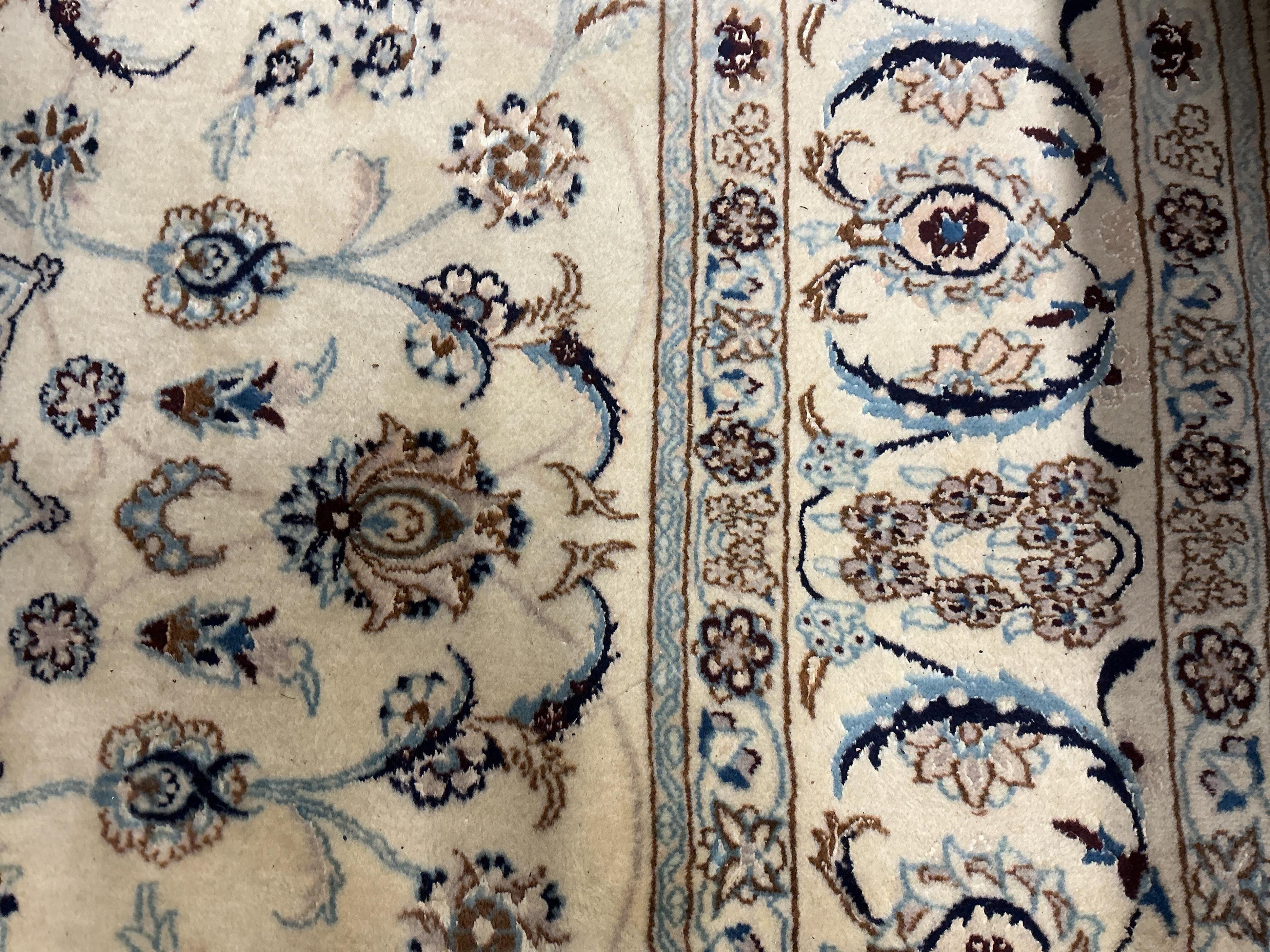 An ivory ground Nain carpet, 300cm x 206cm